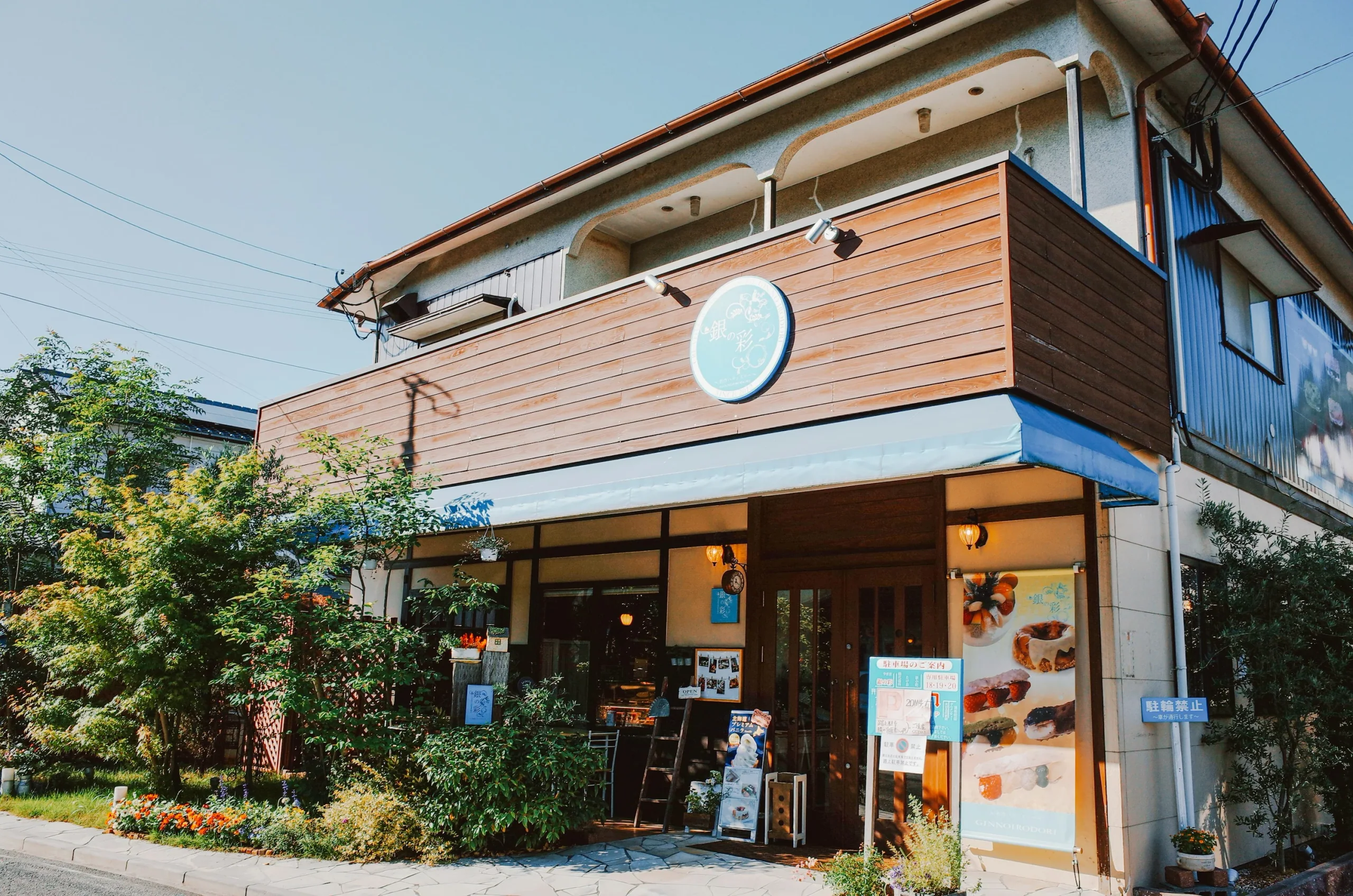 由布院一間烘焙咖啡店的門面、盆栽與甜點海報